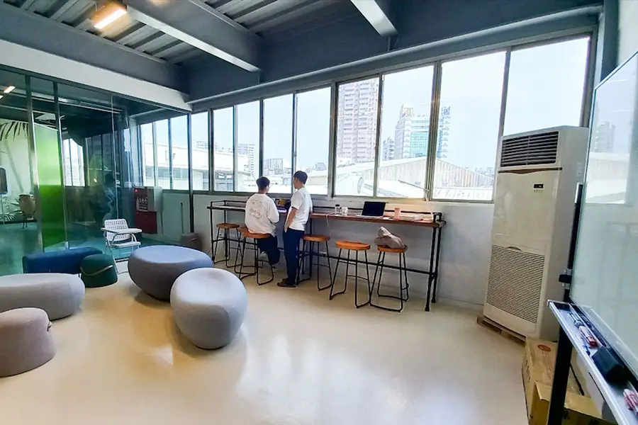 Employees in Quiet Office Area with Expansive Transparent Floor-to-Ceiling Windows
